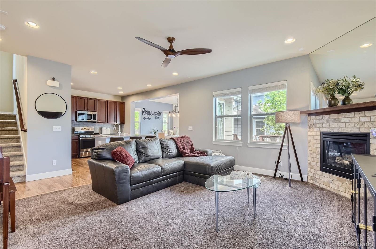 10495 Rutledge Street Parker, CO 80134 - Photo 4 of 32 a living room with furniture a window and a fireplace