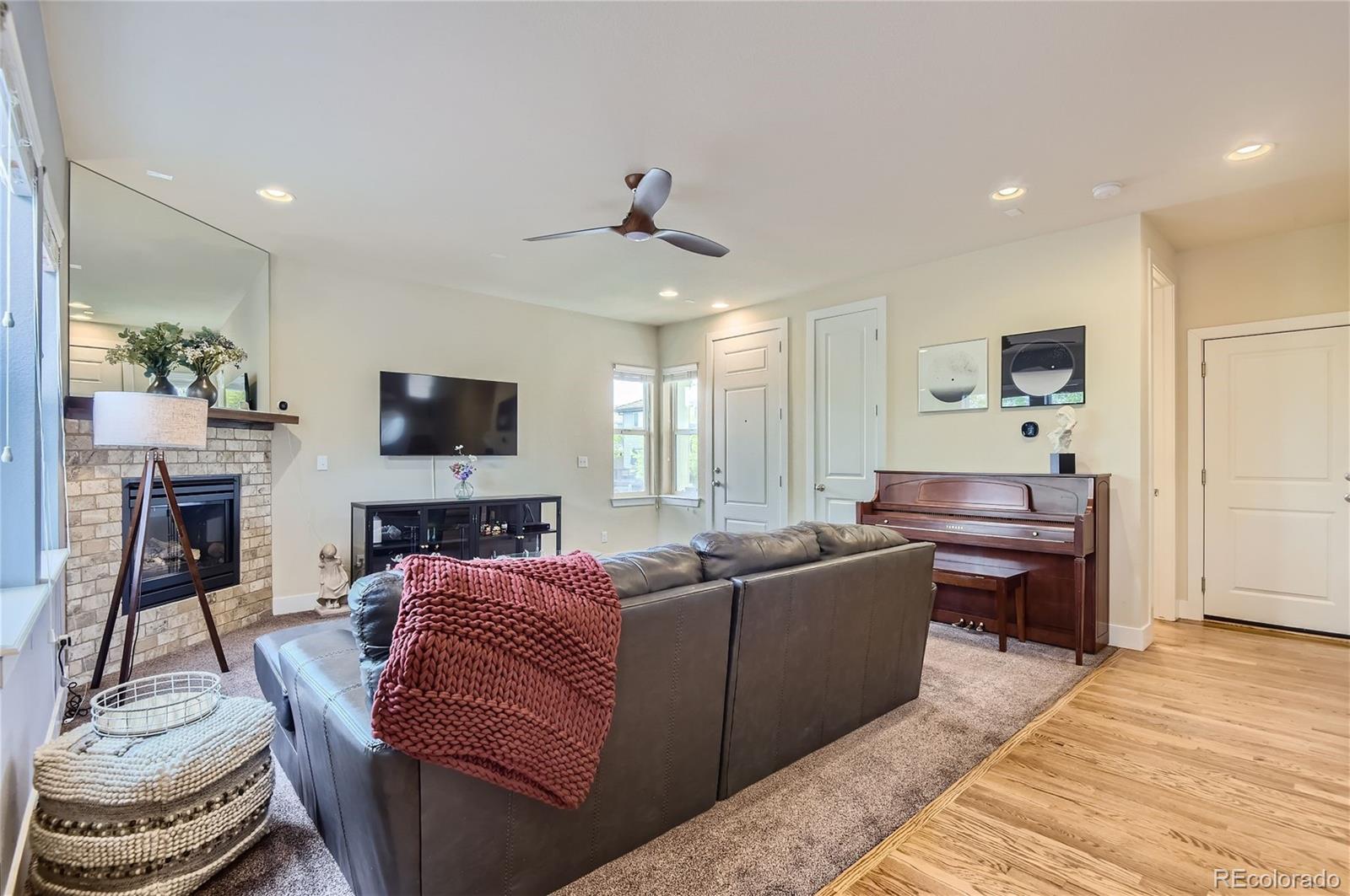 10495 Rutledge Street Parker, CO 80134 - Photo 6 of 32 a living room with furniture and a flat screen tv