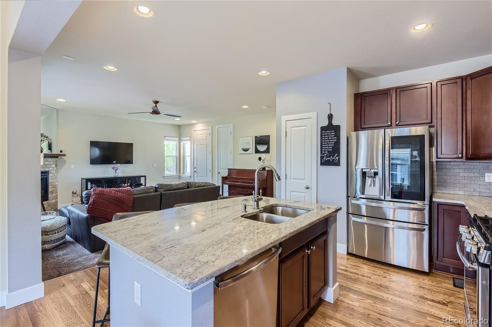 10495 Rutledge Street Parker, CO 80134 - Photo 9 of 32 a kitchen with stainless steel appliances granite countertop a sink refrigerator and cabinets