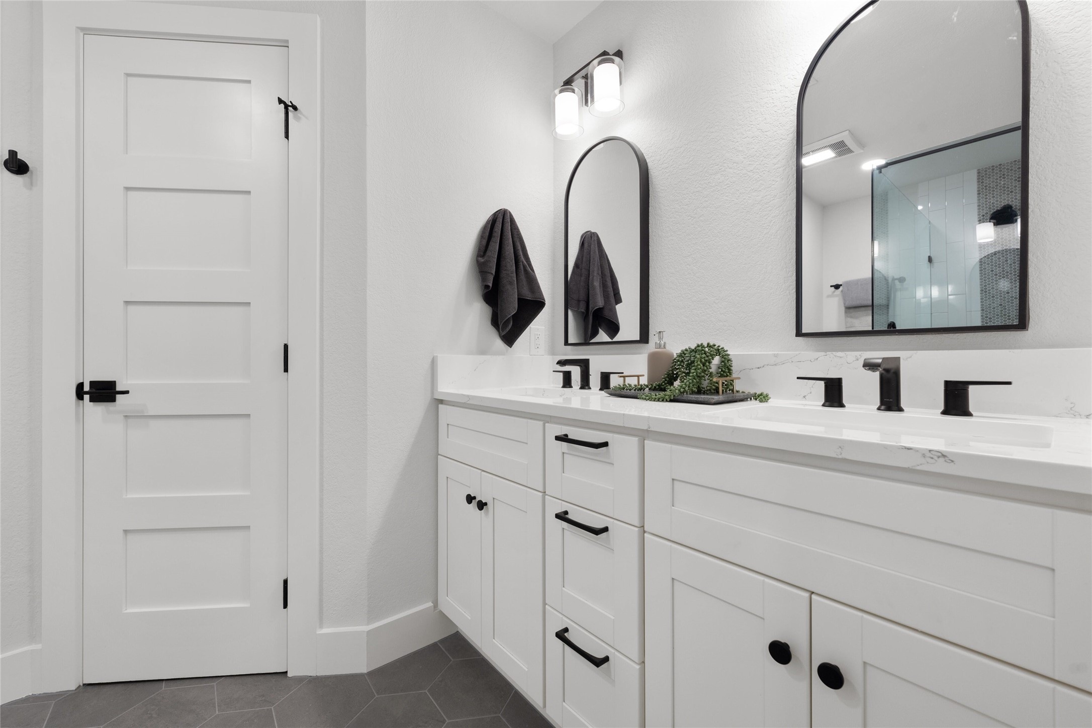 2404 Monarch Drive Austin, TX 78748 - Photo 16 of 25 a bathroom with a double vanity sink and a mirror