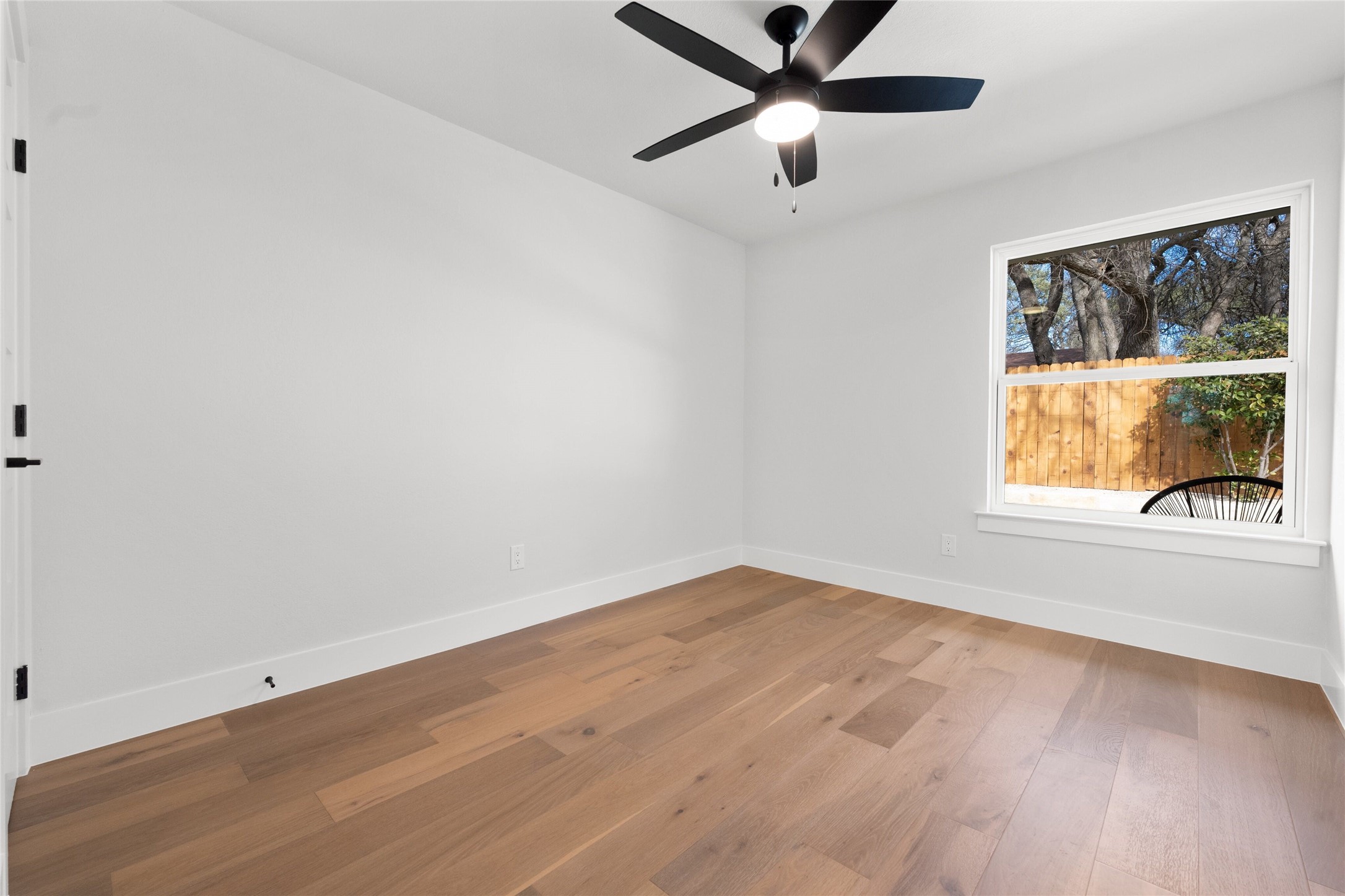 2404 Monarch Drive Austin, TX 78748 - Photo 20 of 25 wooden floor in an empty room with a window