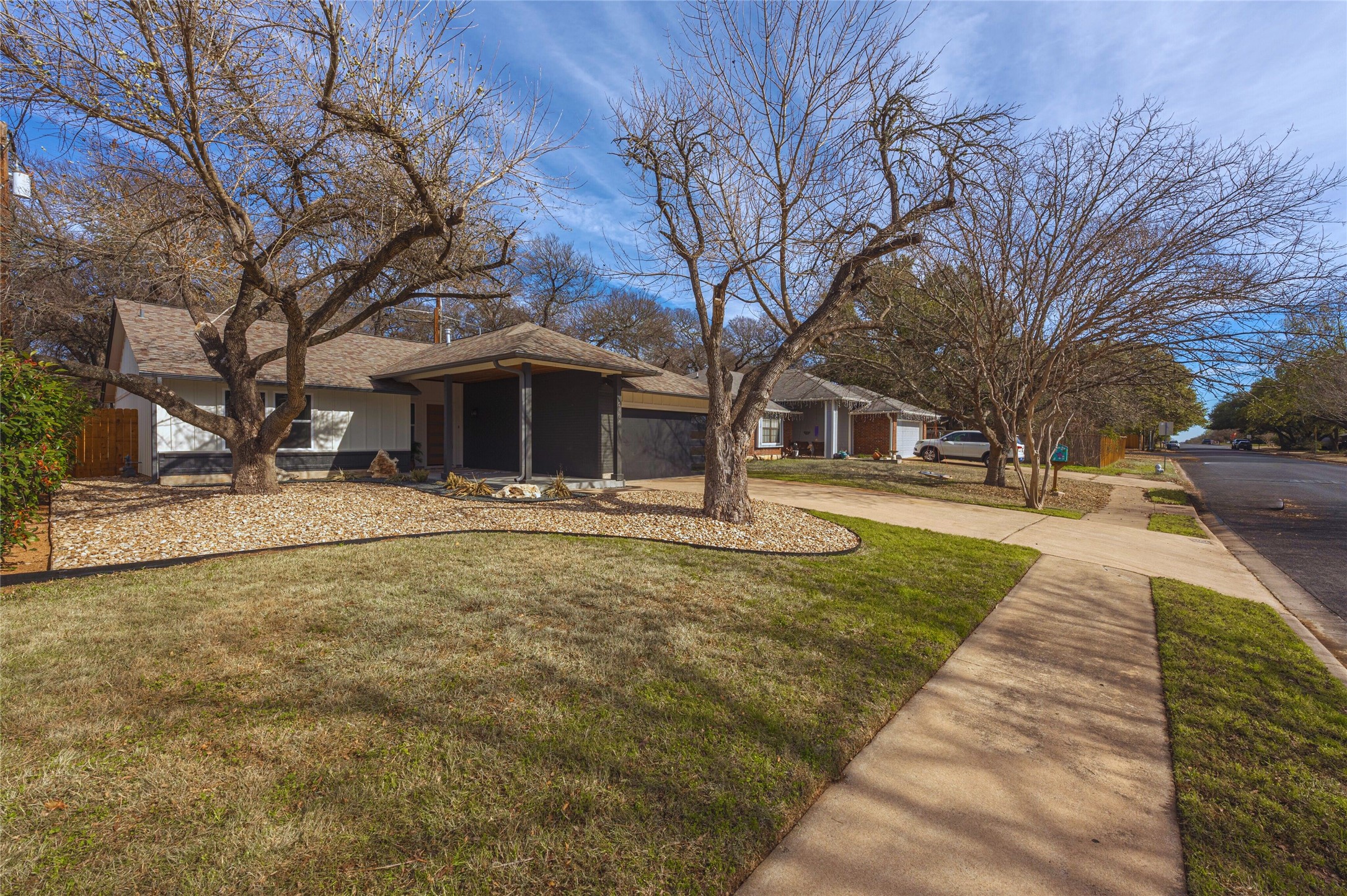 2404 Monarch Drive Austin, TX 78748 - Photo 2 of 25 a front view of a building with large trees
