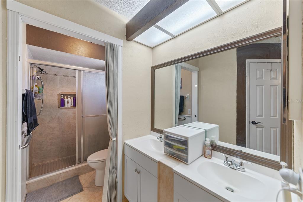 8715 Huntsman Lane Port Richey, FL 34668 - Photo 28 of 54 a bathroom with a sink a toilet a mirror and shower