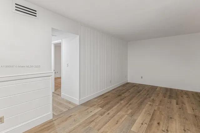 a view of an empty room and wooden floor