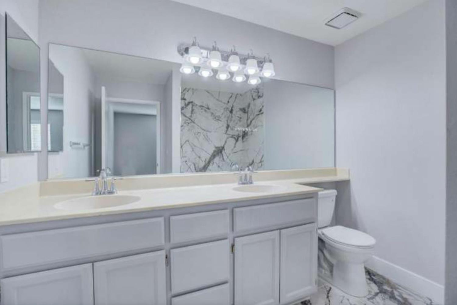 8020 Walerga Road, Unit 1147 Antelope, CA 95843 - Photo 13 of 20 a bathroom with a sink vanity mirror and toilet