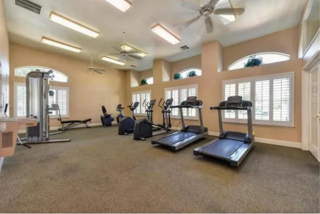 a room with gym equipment and a large window