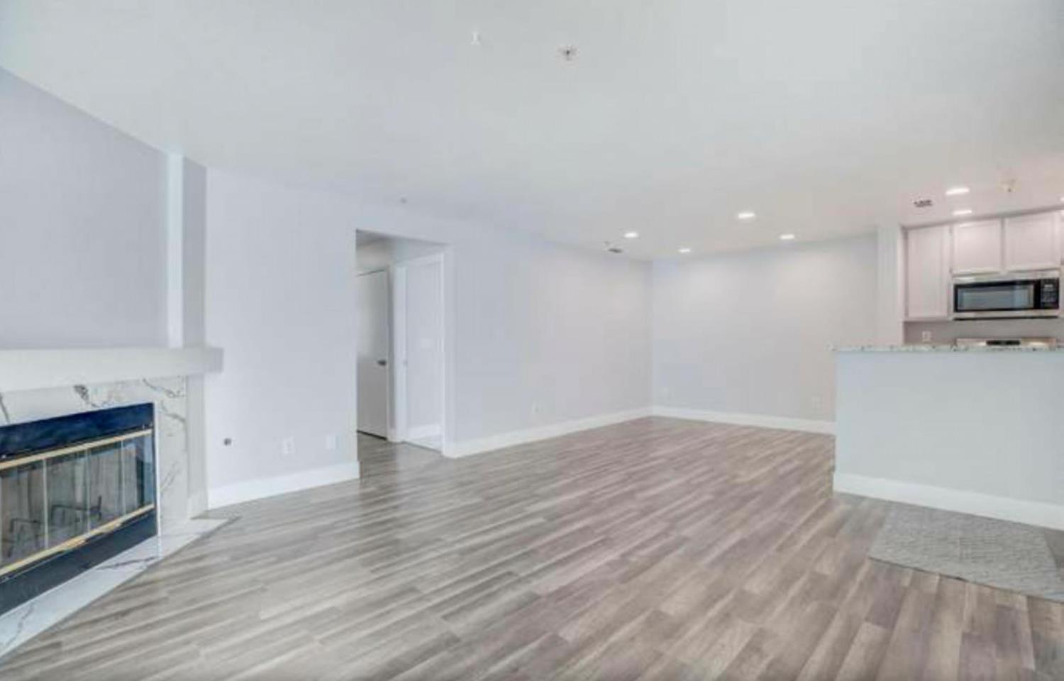 8020 Walerga Road, Unit 1147 Antelope, CA 95843 - Photo 8 of 20 a view of empty room with wooden floor and fireplace