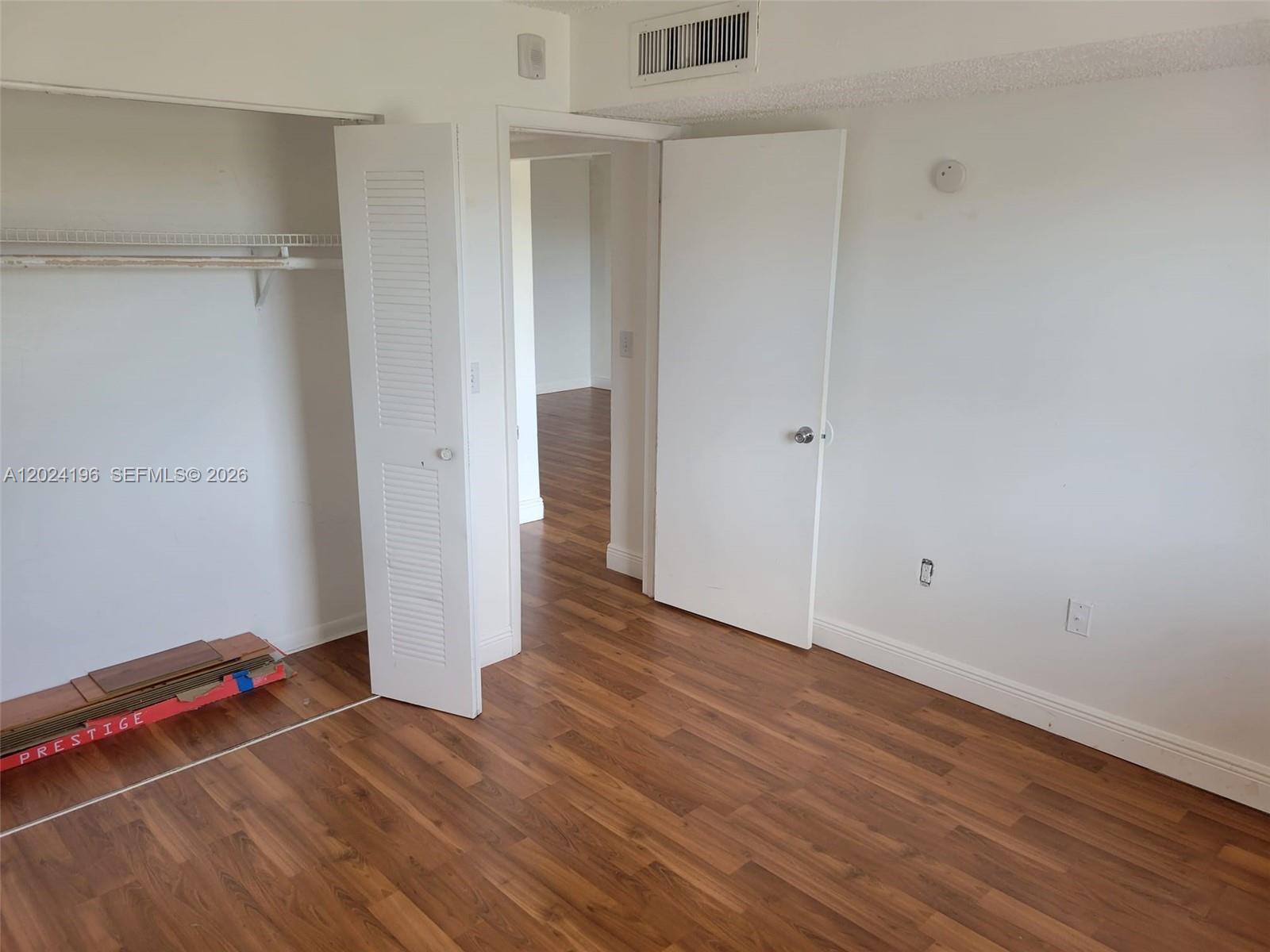 8260 Southwest 210th Street, Unit 319 Cutler Bay, FL 33189 - Photo 9 of 20 a view of room with wooden floor