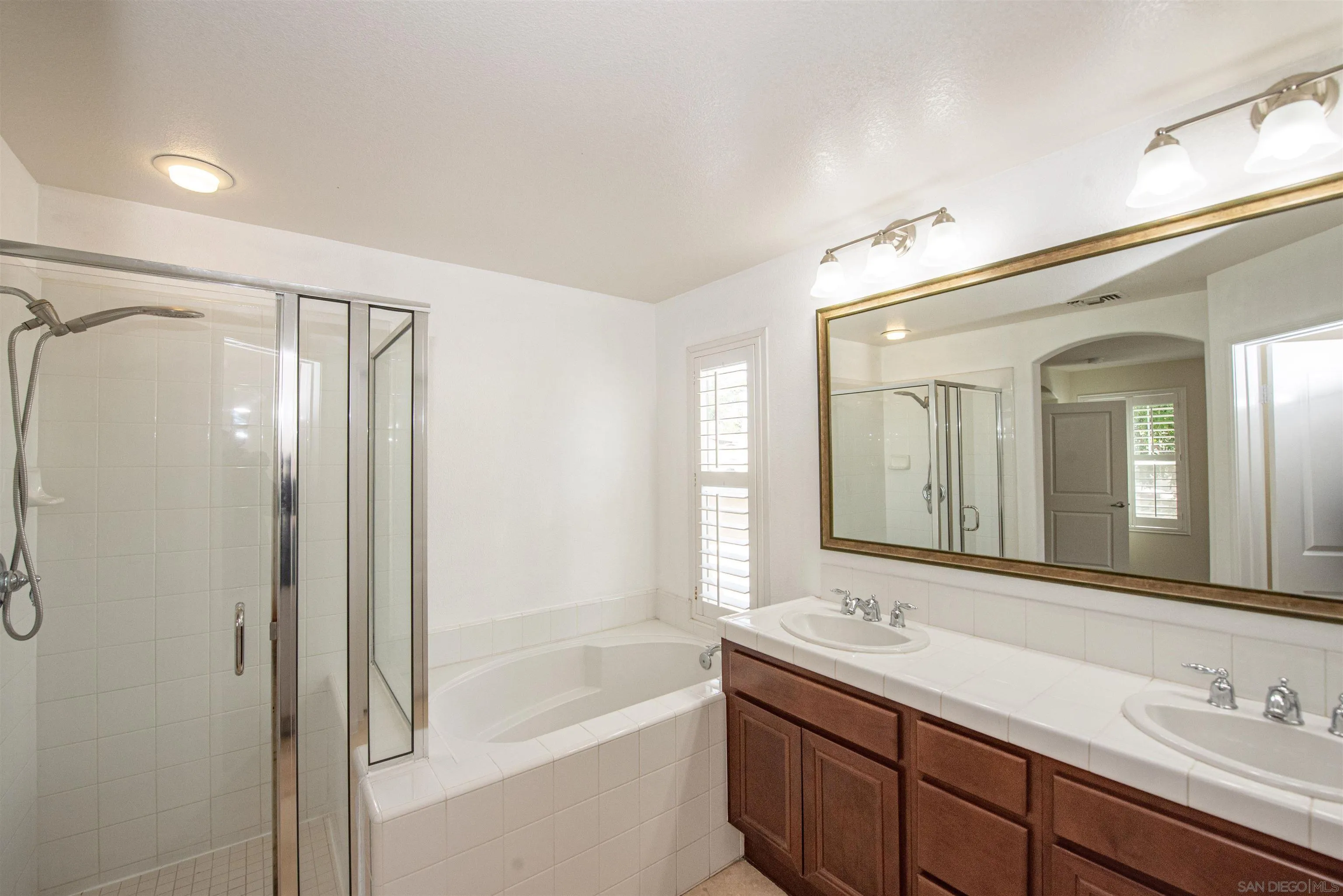 1602 Saddle Ridge Drive Chula Vista, CA 91915 - Photo 16 of 34 a bathroom with a tub sink shower and mirror