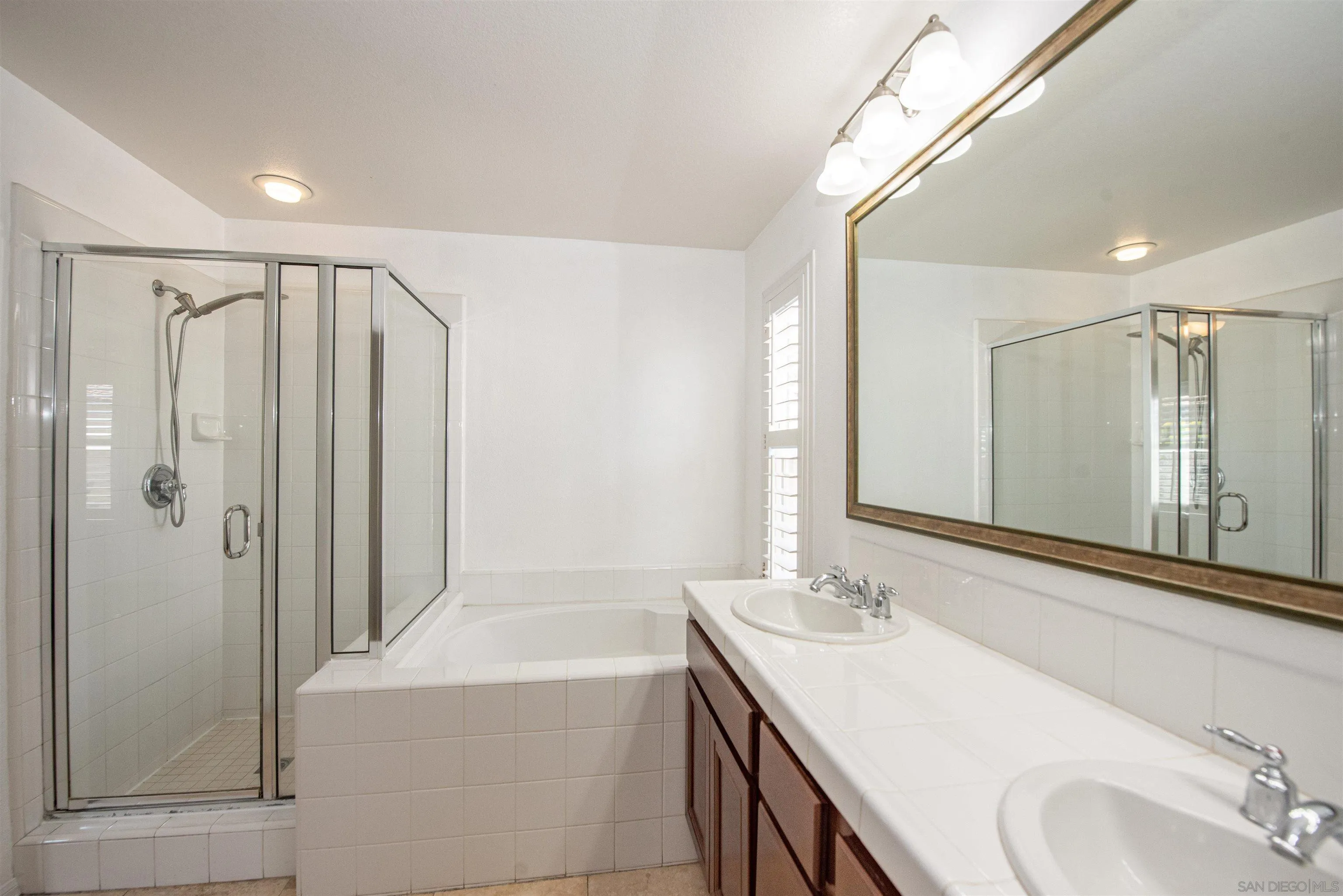 1602 Saddle Ridge Drive Chula Vista, CA 91915 - Photo 17 of 34 a bathroom with a granite countertop sink a mirror and a bathtub