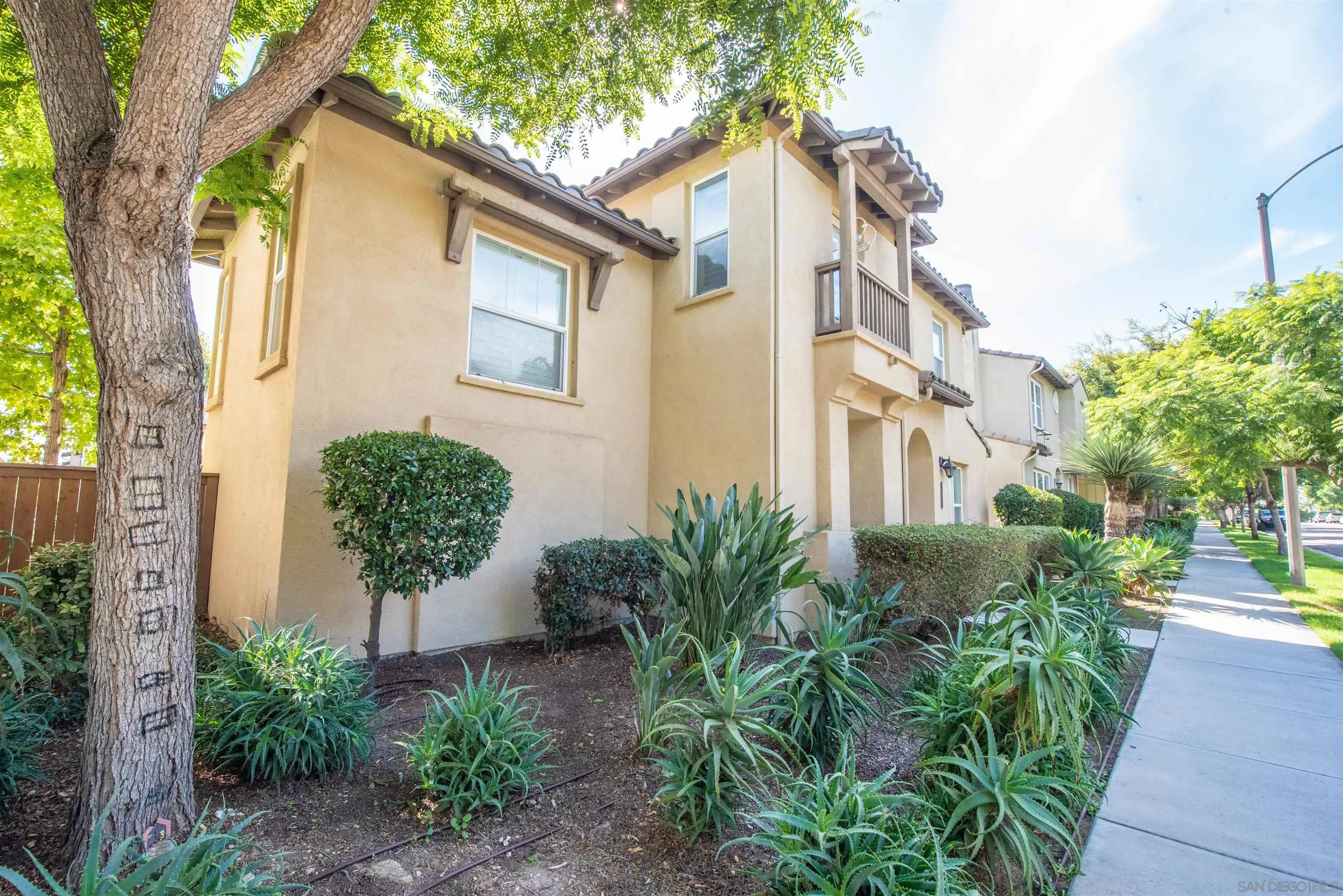 1602 Saddle Ridge Drive Chula Vista, CA 91915 - Photo 33 of 34 a view of a white house next to a yard with plants and trees