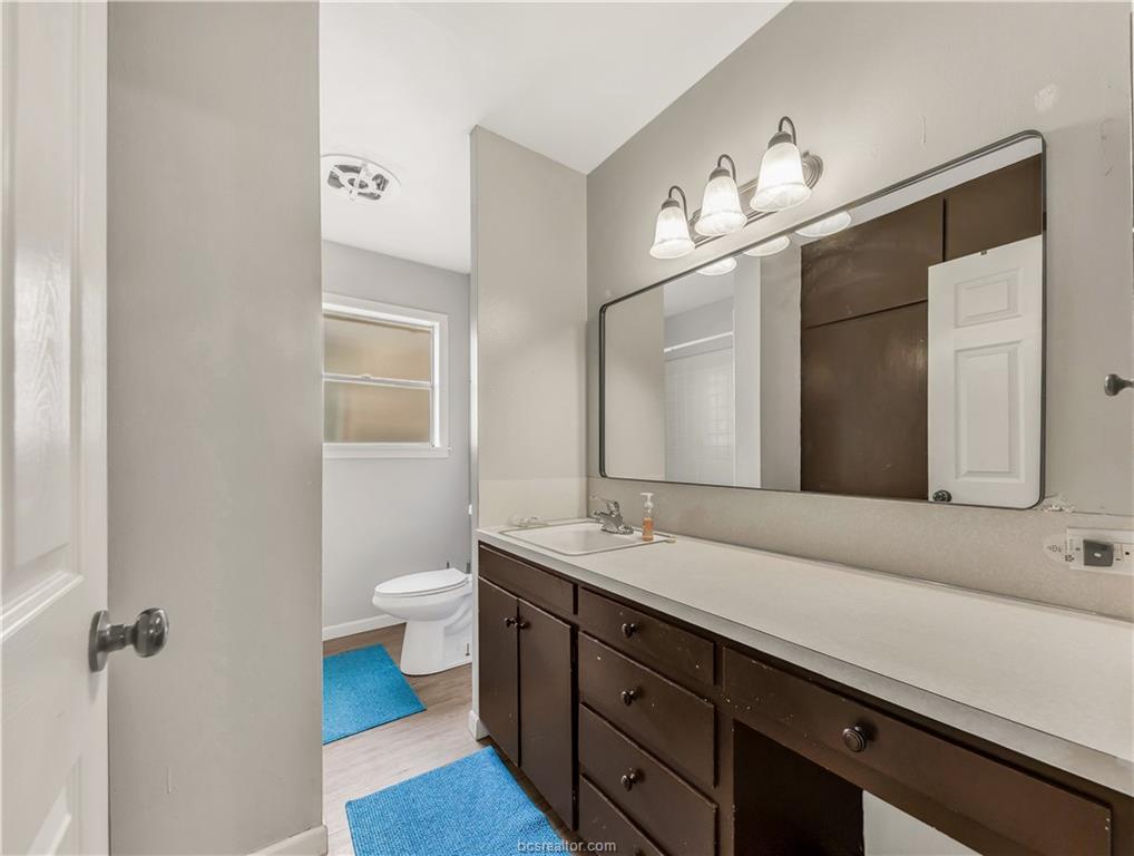 109 Sulphur Springs Road Bryan, TX 77801 - Photo 11 of 15 a bathroom with a double vanity sink and a mirror