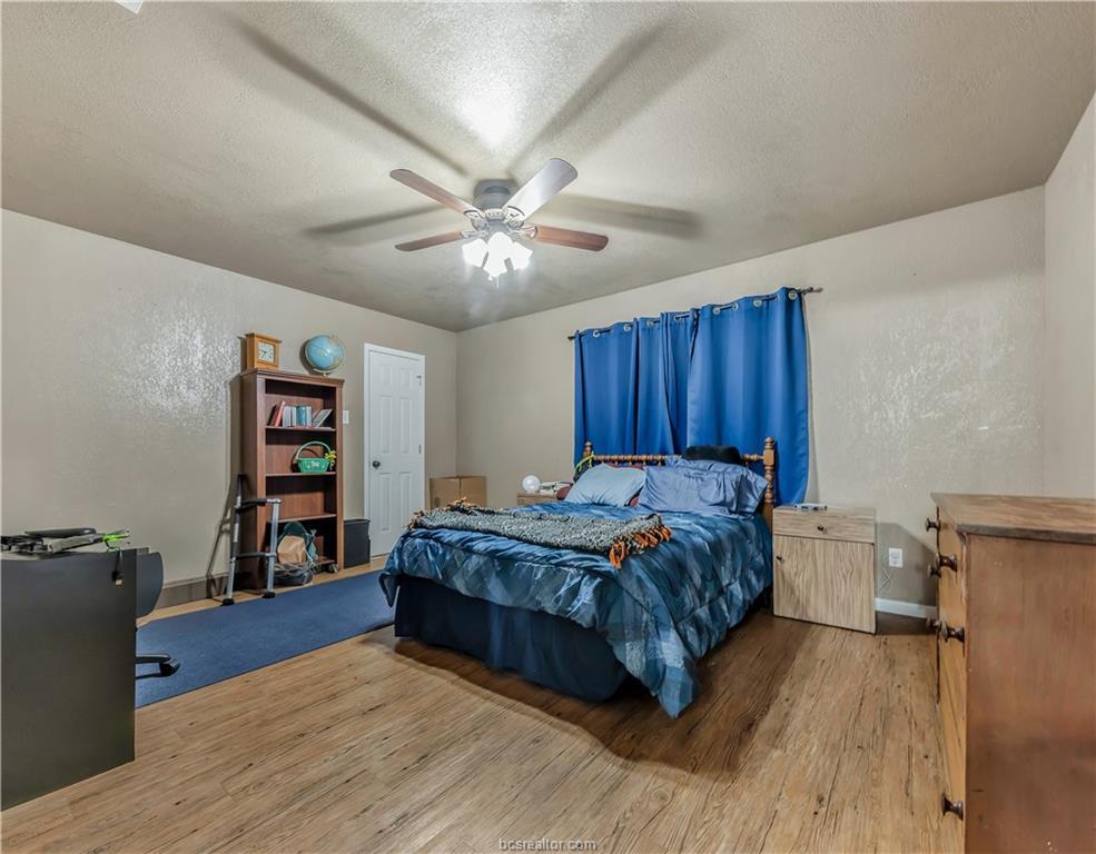 109 Sulphur Springs Road Bryan, TX 77801 - Photo 8 of 15 a spacious bedroom with a bed and a bookshelf