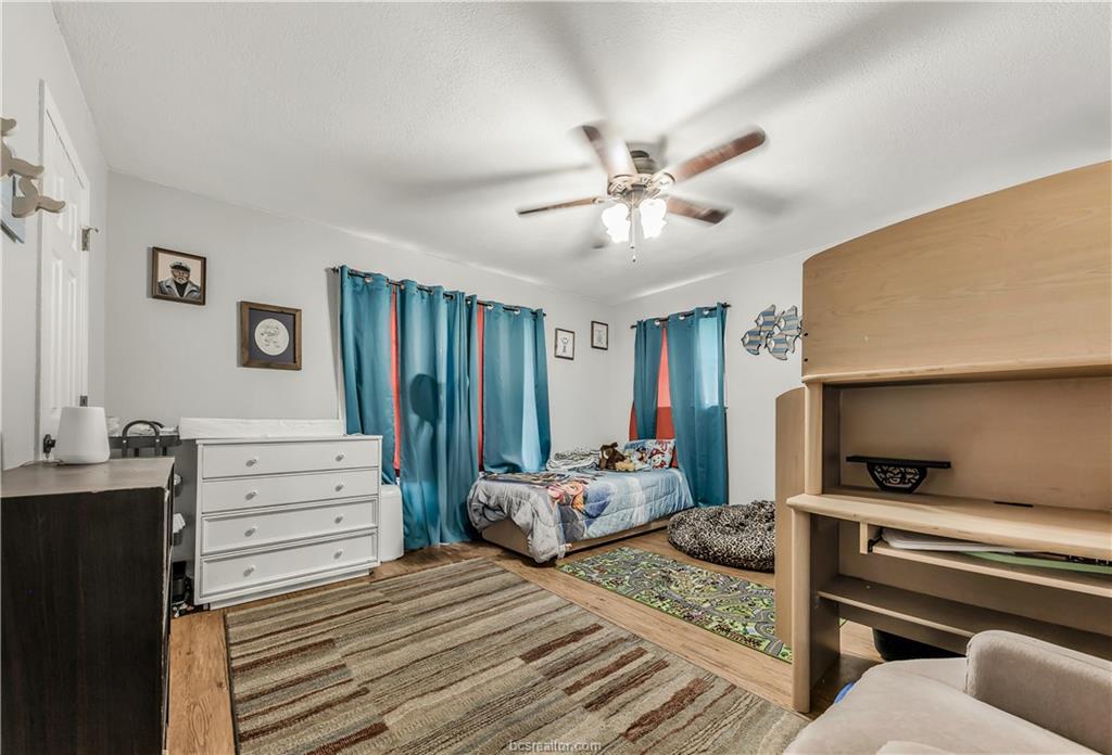 109 Sulphur Springs Road Bryan, TX 77801 - Photo 10 of 15 a bedroom with a bed and a chandelier