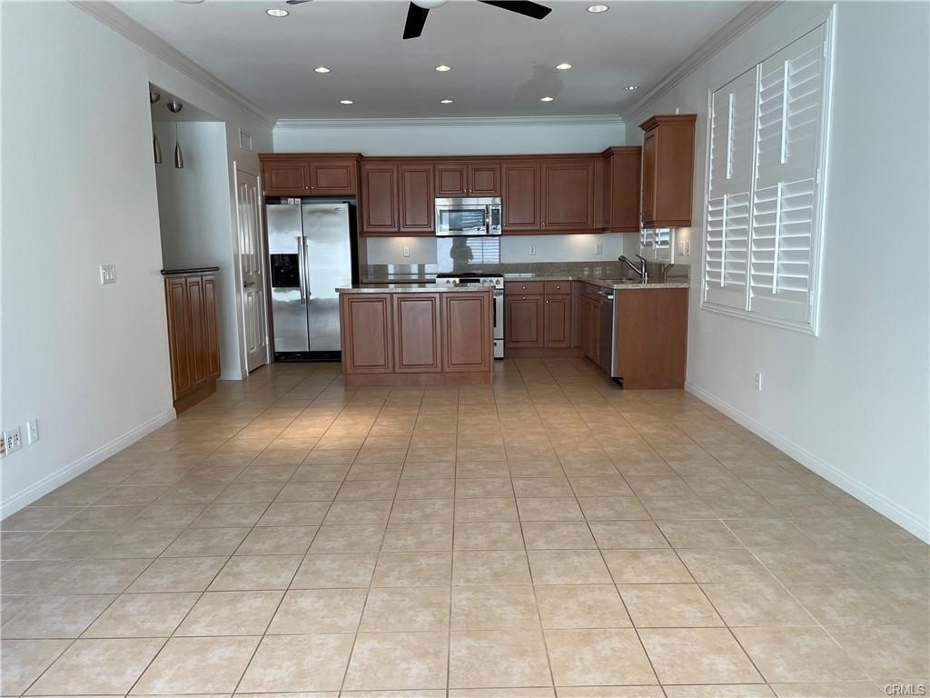91 Splendor Irvine, CA 92618 - Photo 2 of 11 a kitchen with stainless steel appliances granite countertop a refrigerator sink and cabinets