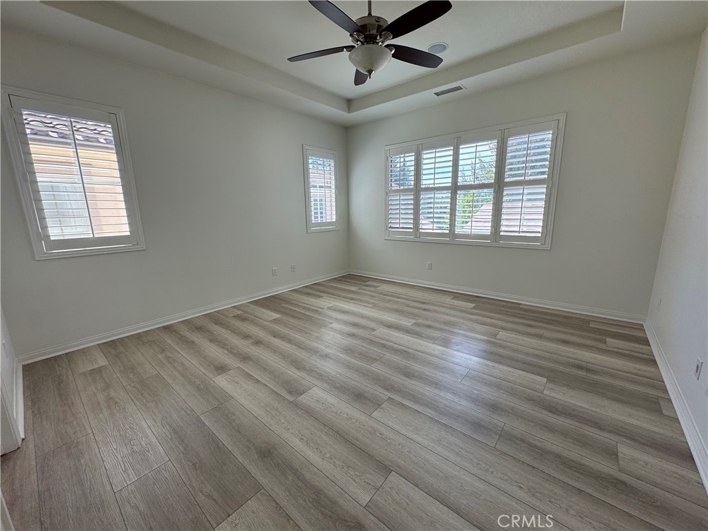 91 Splendor Irvine, CA 92618 - Photo 6 of 11 a view of an empty room with wooden floor and a window