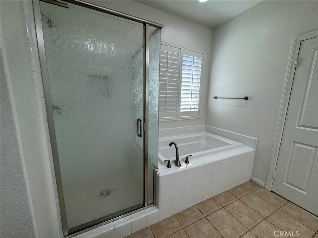 91 Splendor Irvine, CA 92618 - Photo 7 of 11 a bathroom with a tub and a shower