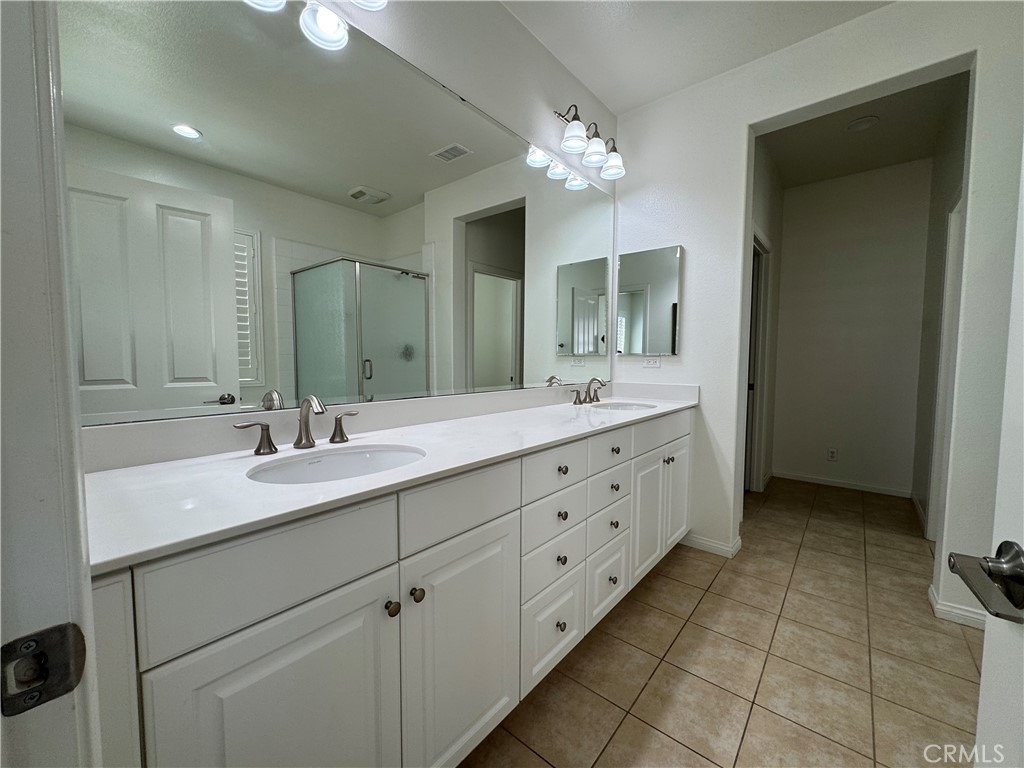91 Splendor Irvine, CA 92618 - Photo 8 of 11 a bathroom with a double vanity sink a mirror and a