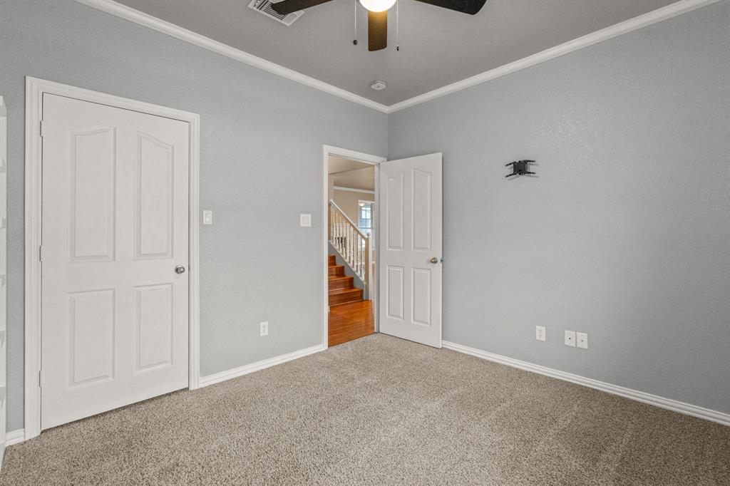 6501 Indian Trail Sanger, TX 76266 - Photo 11 of 39 Unfurnished bedroom with carpet flooring, crown molding, and a ceiling fan