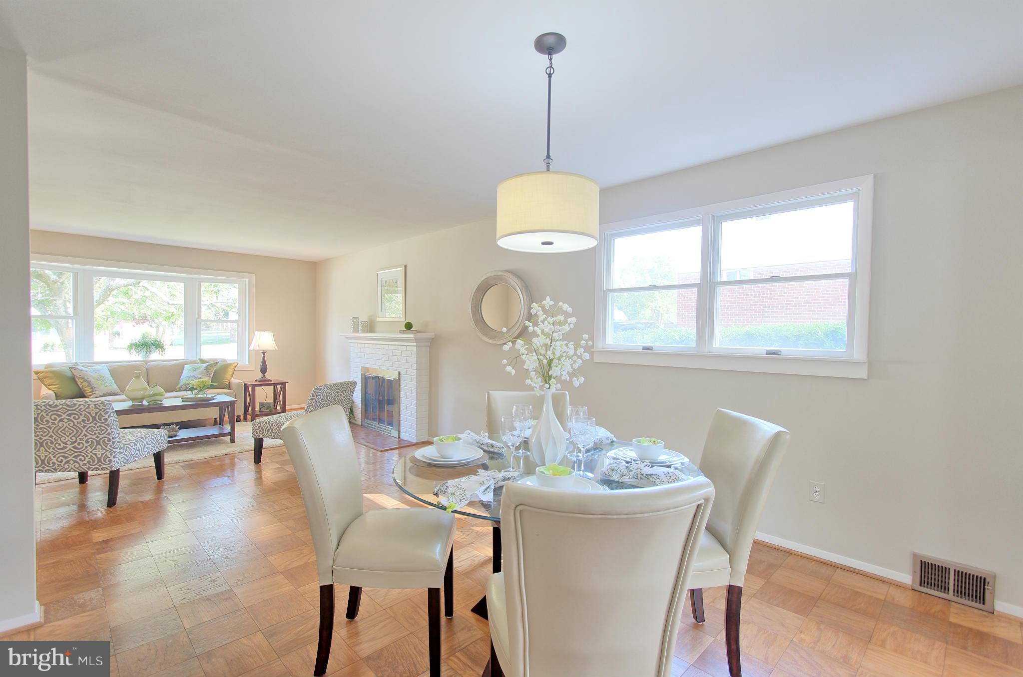 5408 Montgomery Street Springfield, VA 22151 - Photo 11 of 30 a dining room with furniture a chandelier and wooden floor