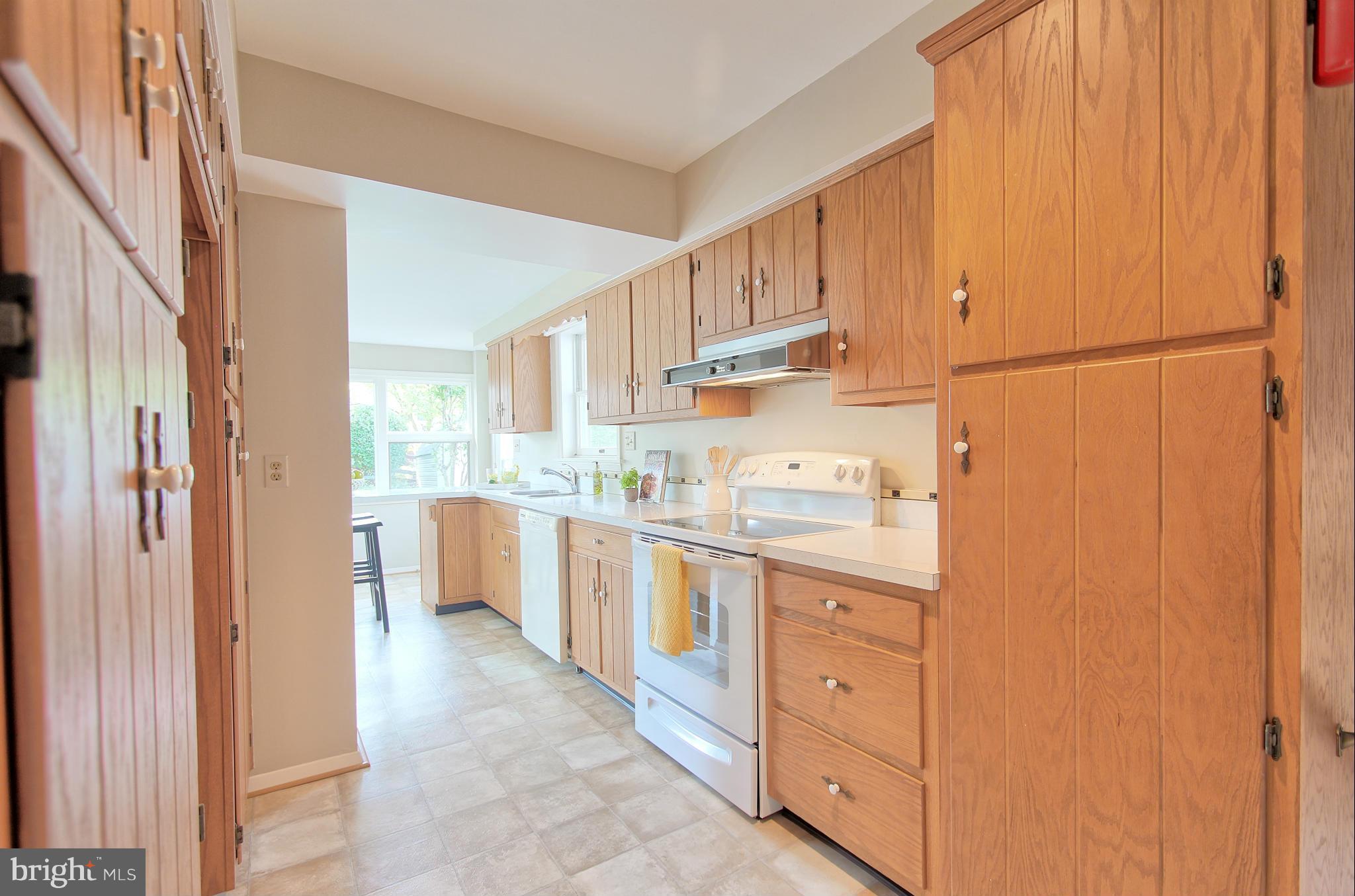 5408 Montgomery Street Springfield, VA 22151 - Photo 17 of 30 a kitchen with granite countertop a refrigerator and white cabinets