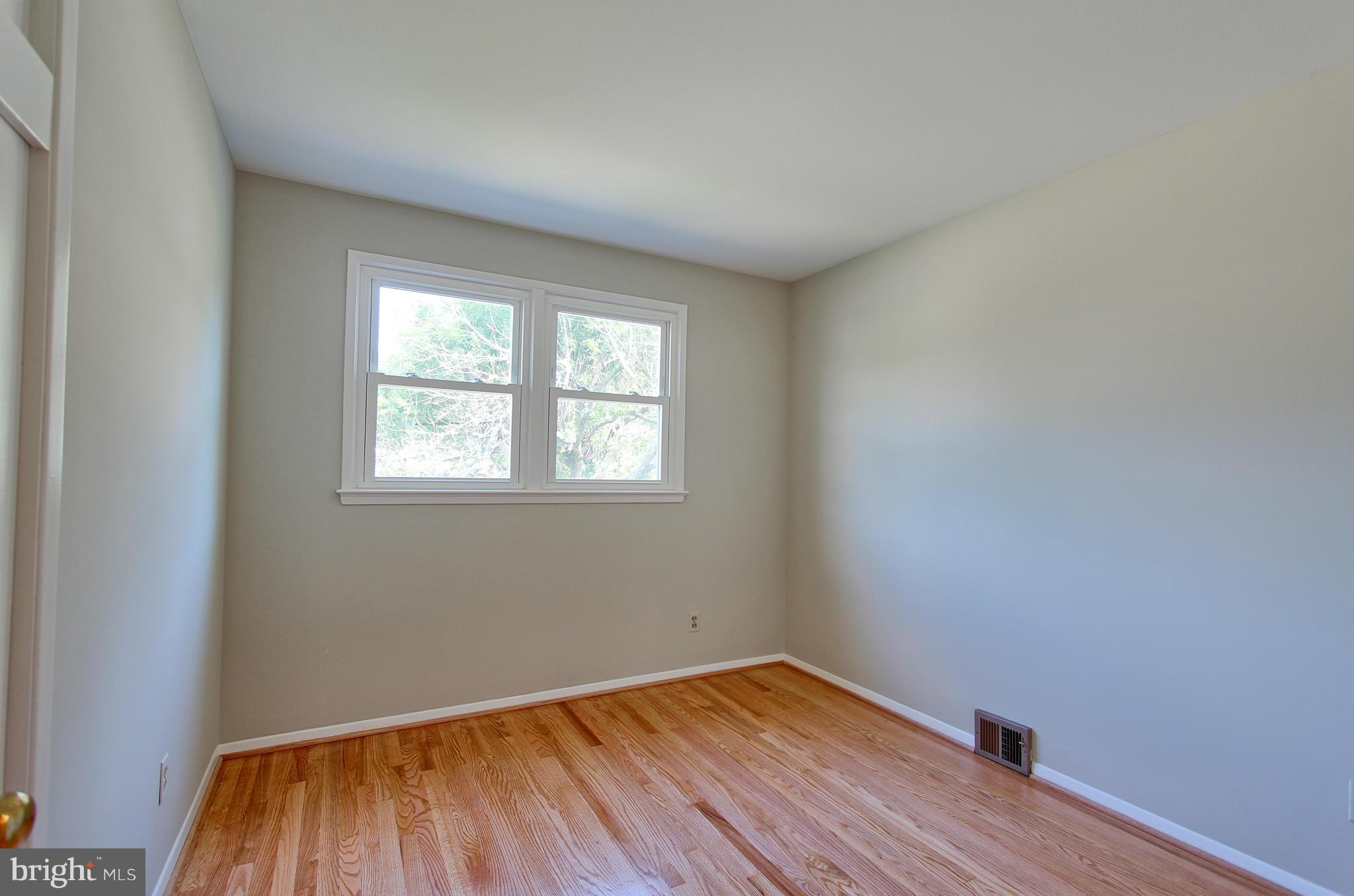 5408 Montgomery Street Springfield, VA 22151 - Photo 27 of 30 an empty room with wooden floor and windows