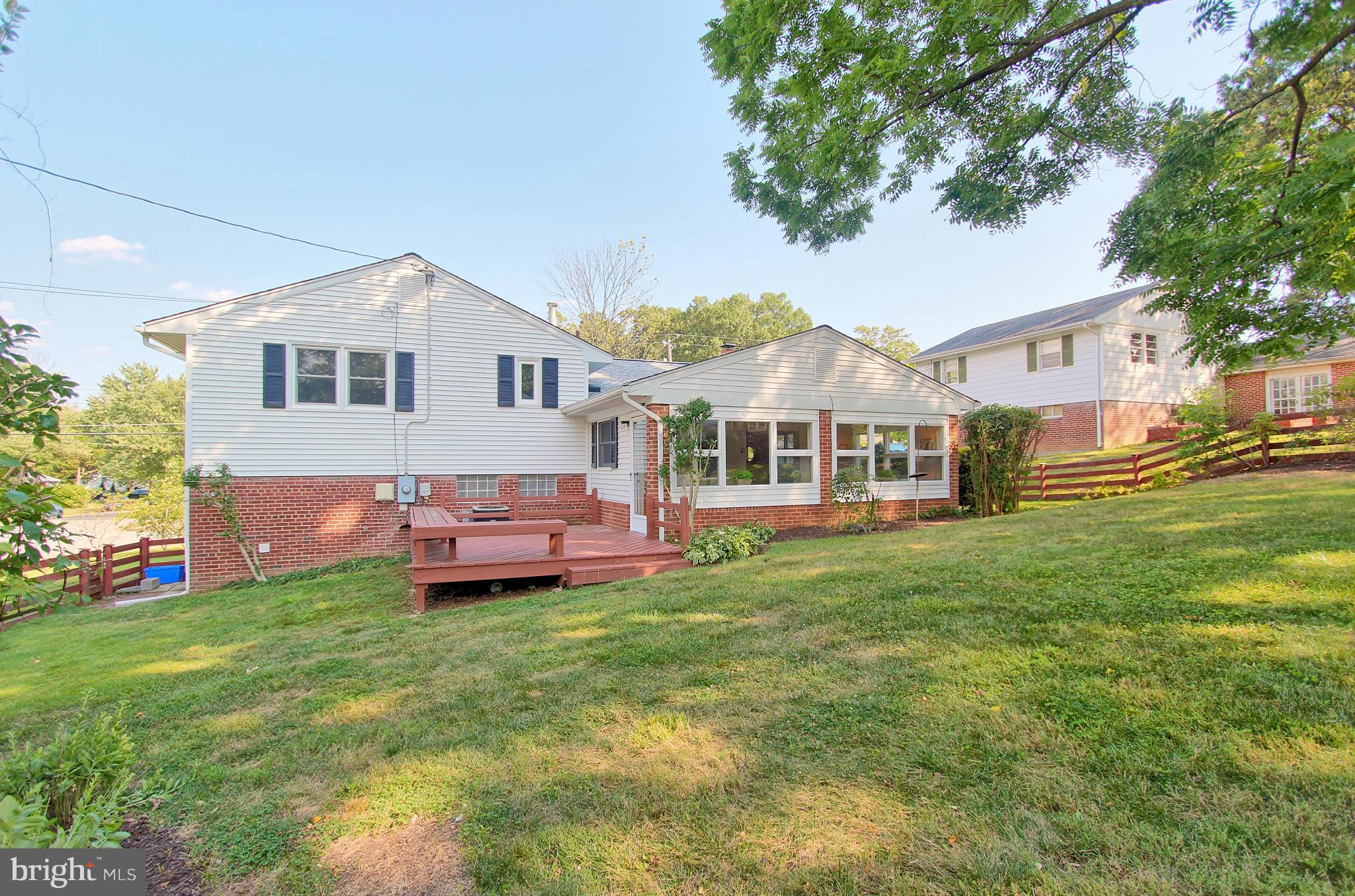 5408 Montgomery Street Springfield, VA 22151 - Photo 4 of 30 a front view of a house with a garden and deck