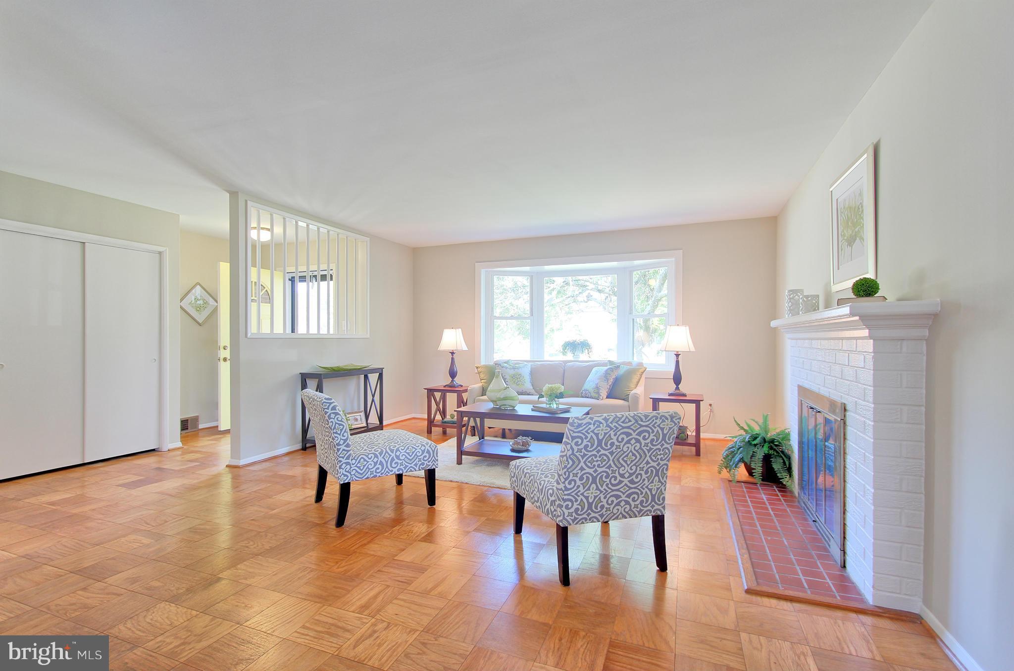 5408 Montgomery Street Springfield, VA 22151 - Photo 5 of 30 a living room with furniture and a fireplace