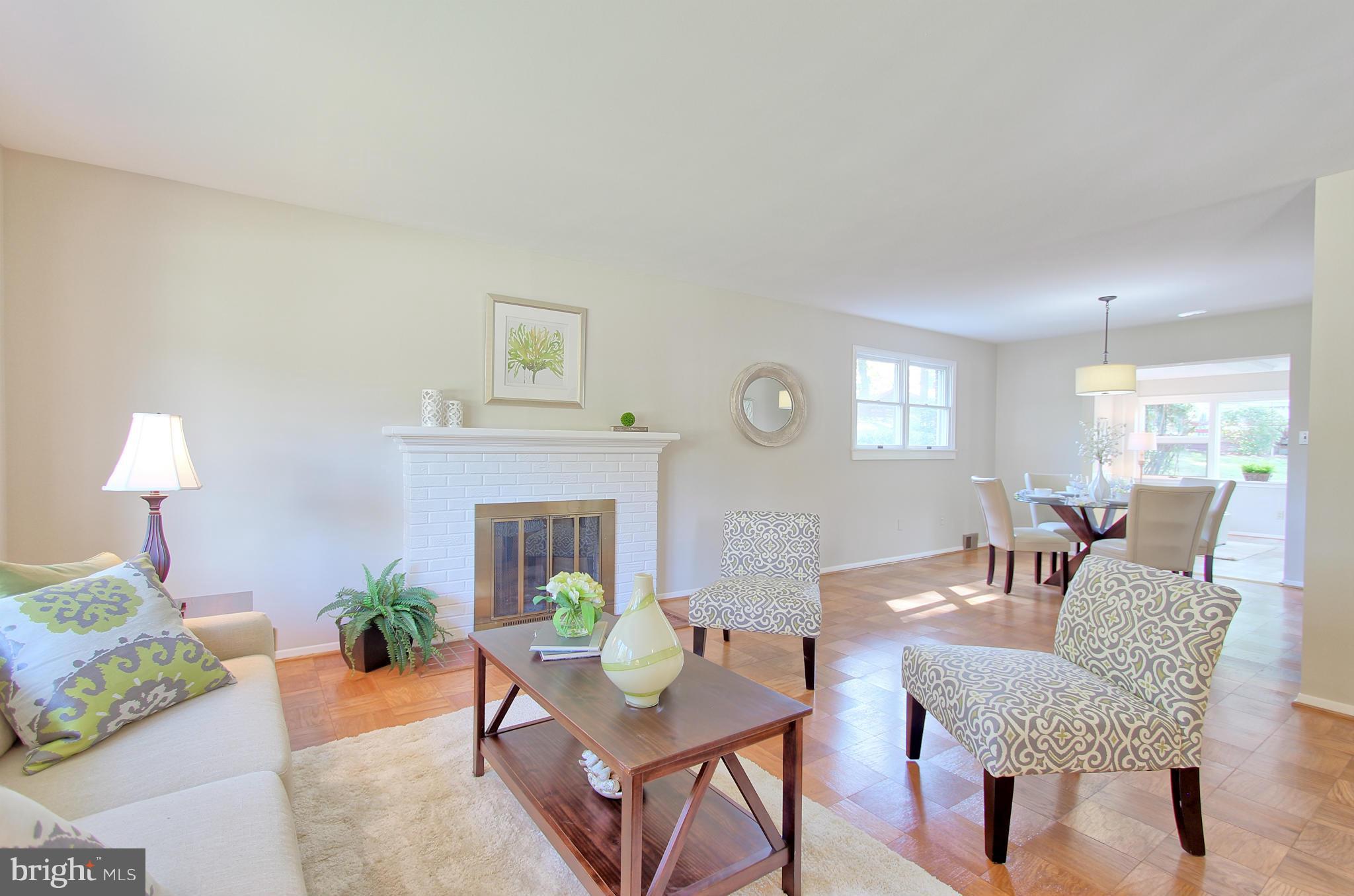 5408 Montgomery Street Springfield, VA 22151 - Photo 7 of 30 a dining room with furniture a fireplace and a potted plants