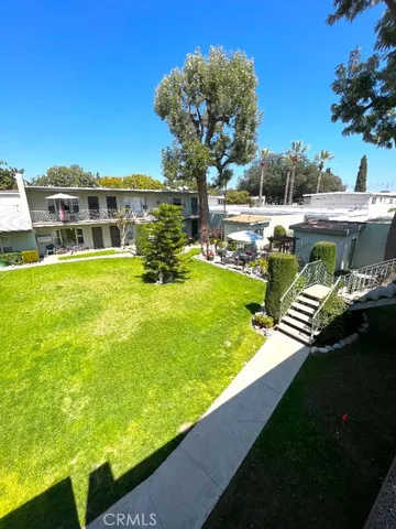 a view of a swimming pool with an outdoor seating and a yard