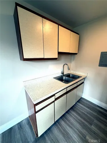 a kitchen with wooden cabinets and a wooden floor
