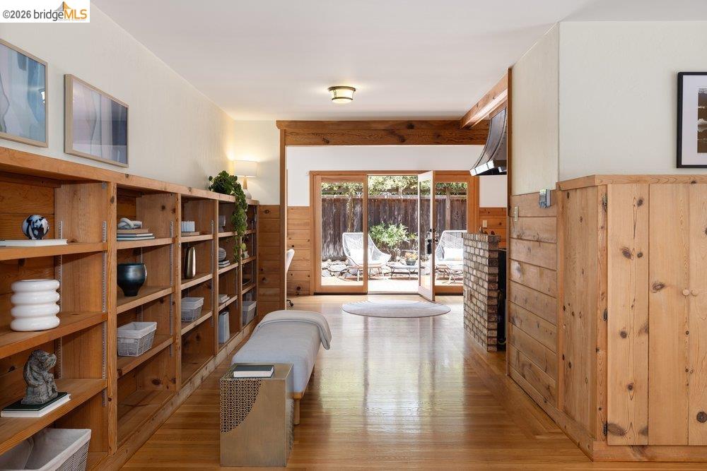 287 Purdue Avenue Kensington, CA 94708 - Photo 19 of 60 Hardwood flooring extends throughout the space, complemented by extensive built-in shelving and wood paneling