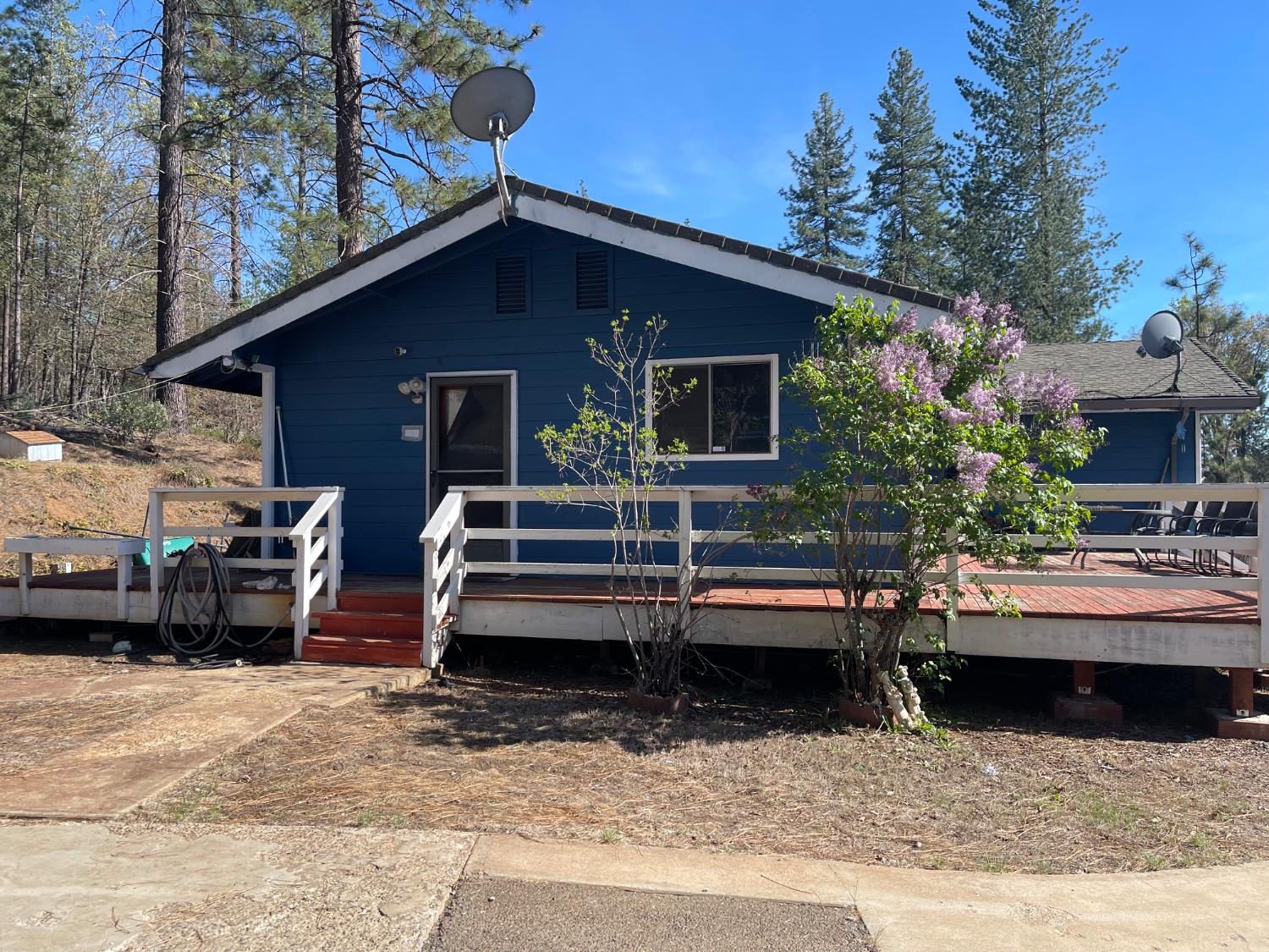 a view of house and a yard with patio