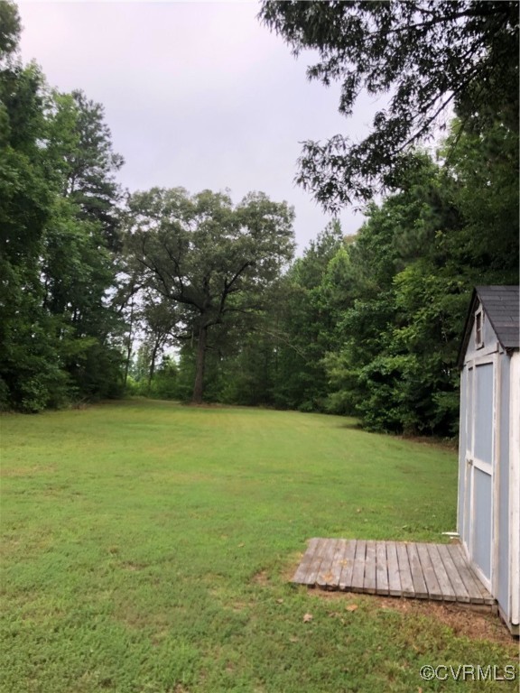 13606 Halifax Road Richmond, VA 23238 - Photo 11 of 50 View of green lawn with a shed