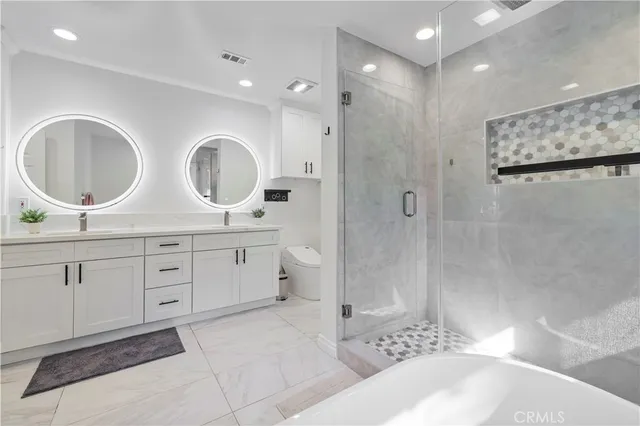 a spacious bathroom with double sink and a mirror