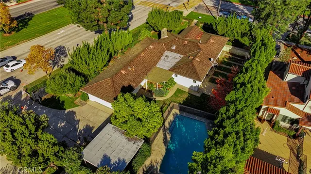 an aerial view of a house with a yard and garden