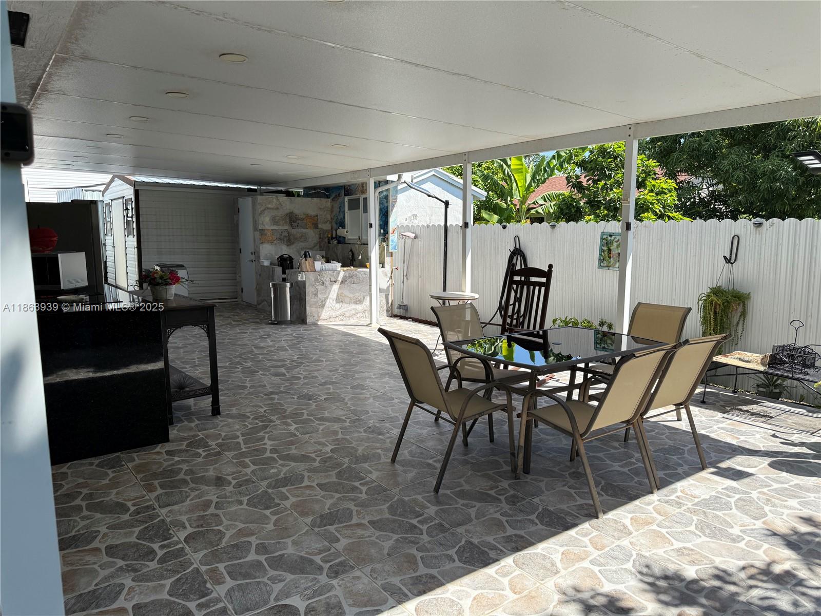 6553 Southwest 148th Court Miami, FL 33193 - Photo 6 of 6 a dining room with furniture and a floor to ceiling window