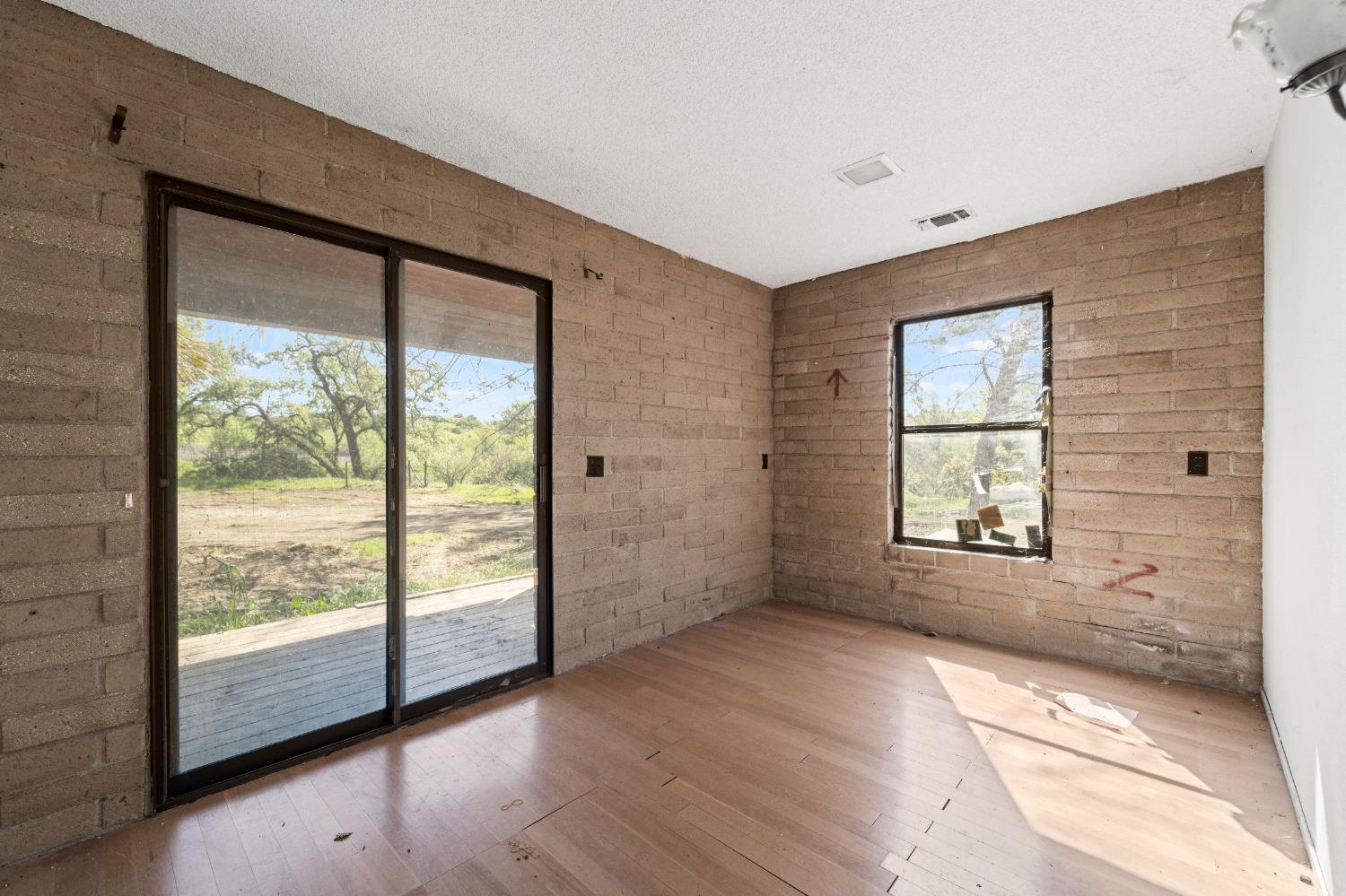 15595 Highway 16 Capay, CA 95607 - Photo 11 of 68 a view of empty room with wooden floor and fan