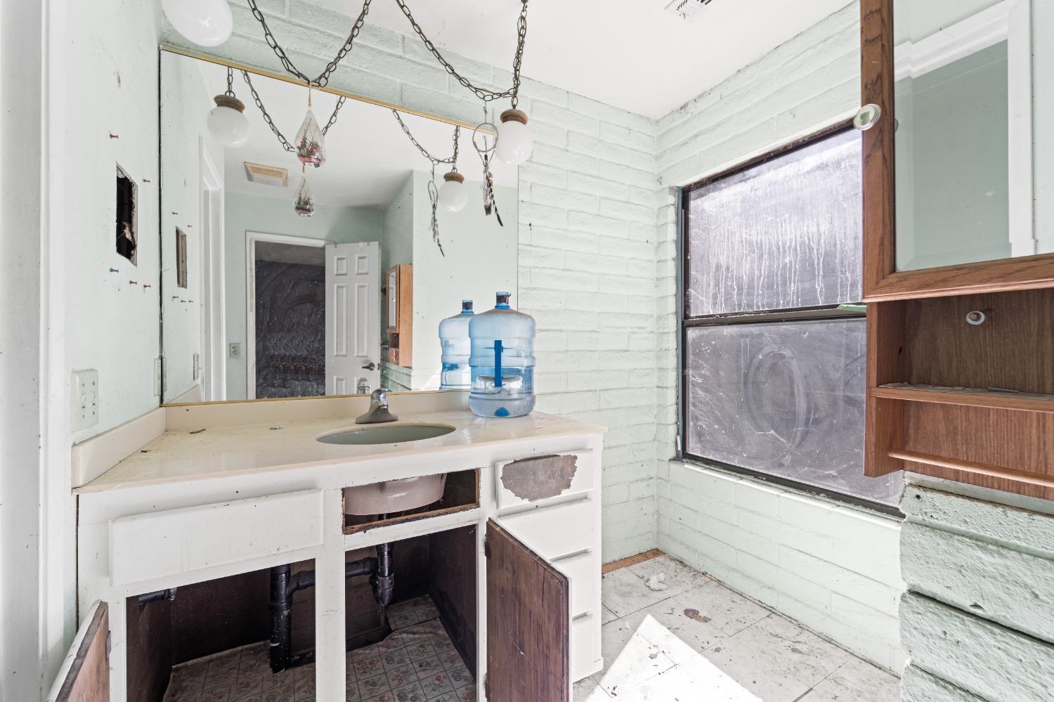 15595 Highway 16 Capay, CA 95607 - Photo 28 of 68 a kitchen with a table chairs refrigerator and cabinets