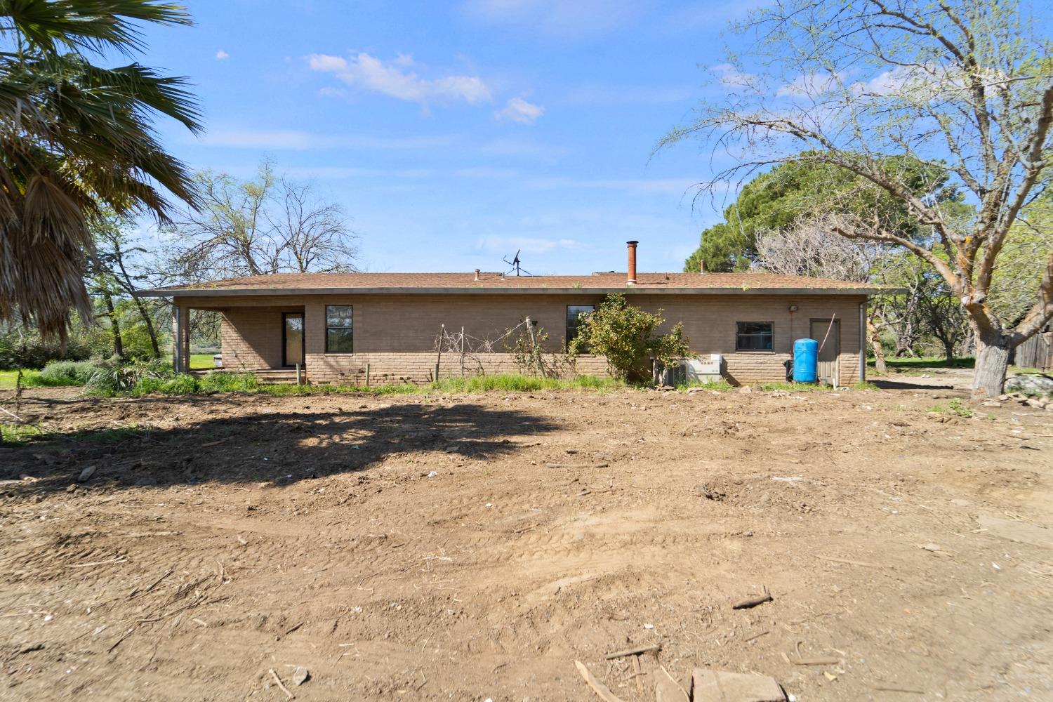 15595 Highway 16 Capay, CA 95607 - Photo 36 of 68 a front view of a house with a yard and potted plants