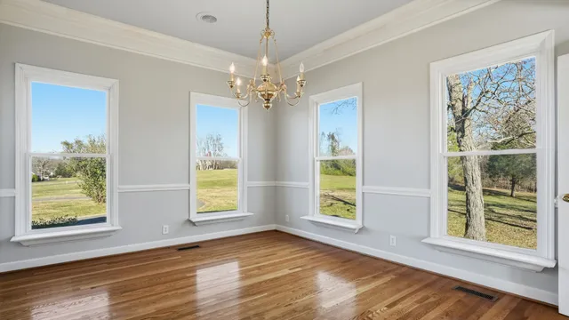 a kitchen with granite countertop a sink and a wooden floor