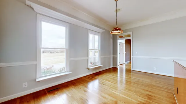 a spacious bathroom with a granite countertop sink a mirror and a shower