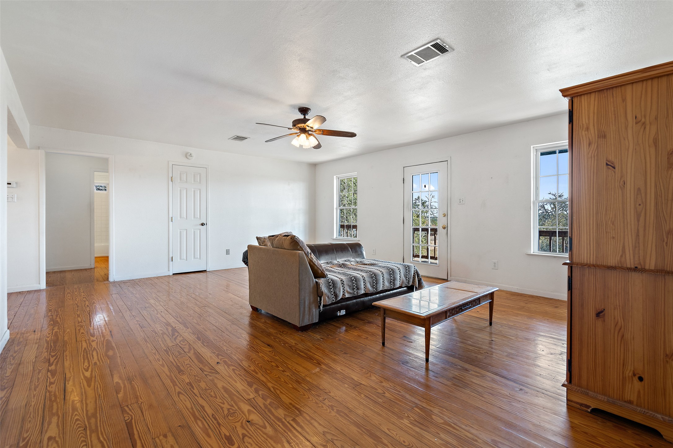 1401 Pursley Road Dripping Springs, TX 78620 - Photo 14 of 35 Living area with hardwood / wood-style flooring, plenty of natural light, and ceiling fan