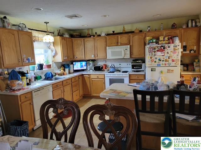 2137 Freedom Way Pocono Summit, PA 18346 - Photo 18 of 33 a kitchen with sink a stove and chairs