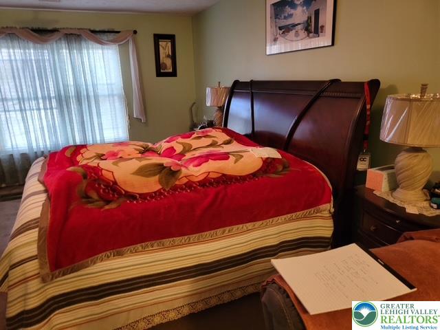2137 Freedom Way Pocono Summit, PA 18346 - Photo 23 of 33 a bedroom with a bed and wooden floor