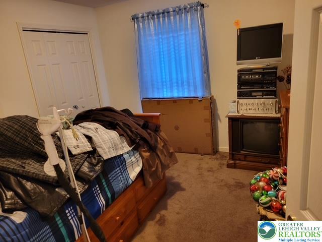 2137 Freedom Way Pocono Summit, PA 18346 - Photo 32 of 33 a bed sitting in a bedroom next to a flat screen tv and a window