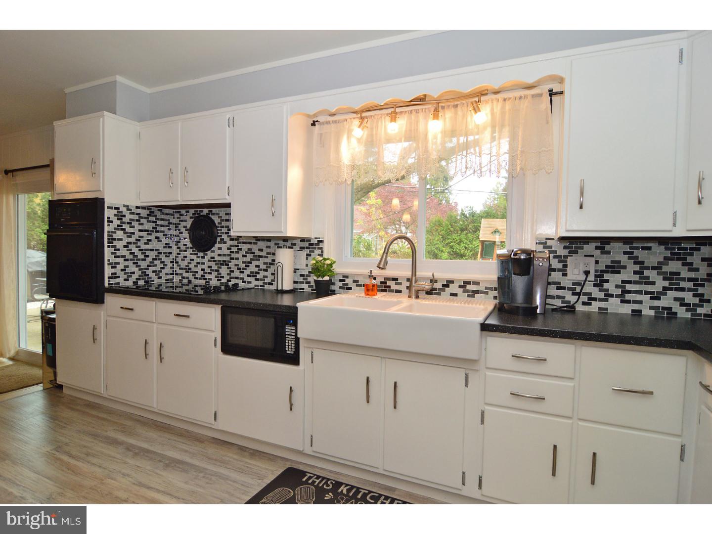 6 Wendy Road Reading, PA 19601 - Photo 9 of 24 a kitchen with white cabinets a sink a stove and white stainless steel appliances