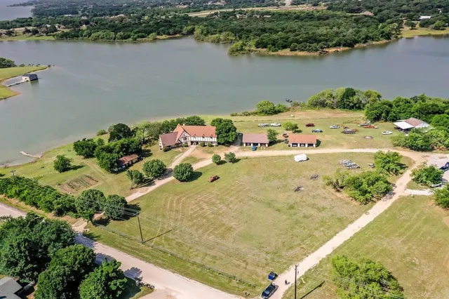 an aerial view of a house with a lake view