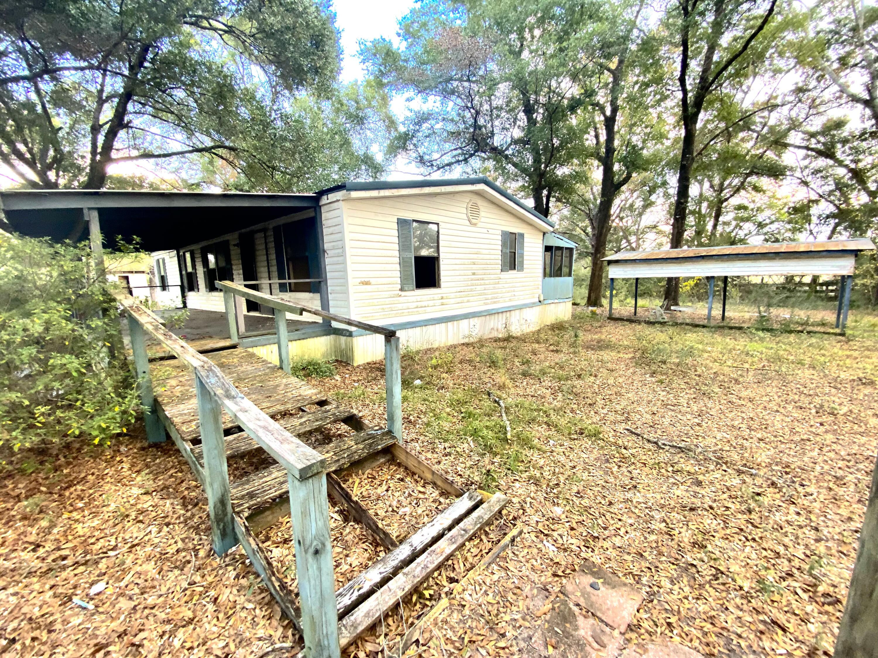 a view of house with backyard seating and swimming pool