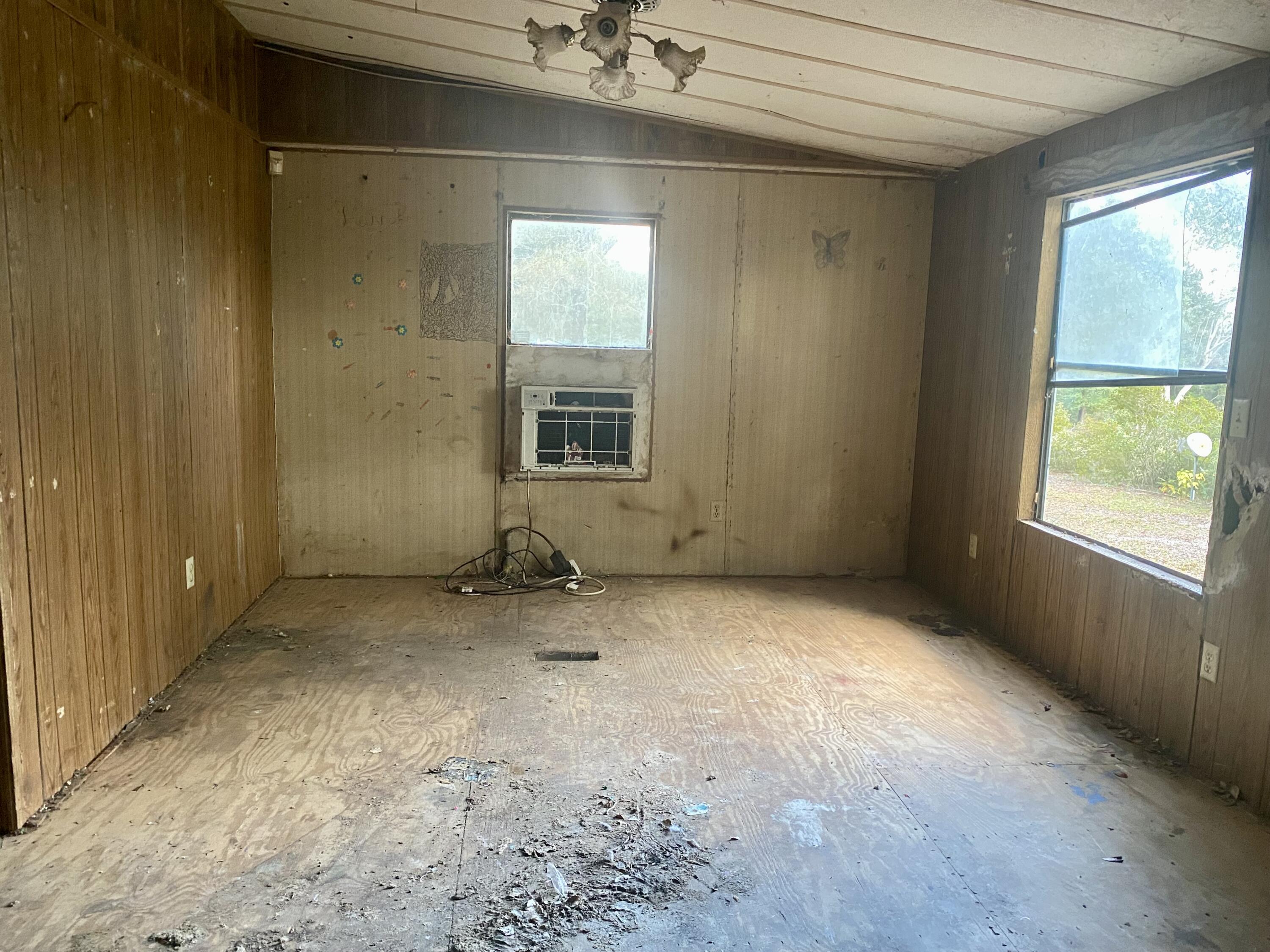 4977 Douglas Ferry Road Caryville, FL 32427 - Photo 12 of 16 an empty room with a empty space and windows
